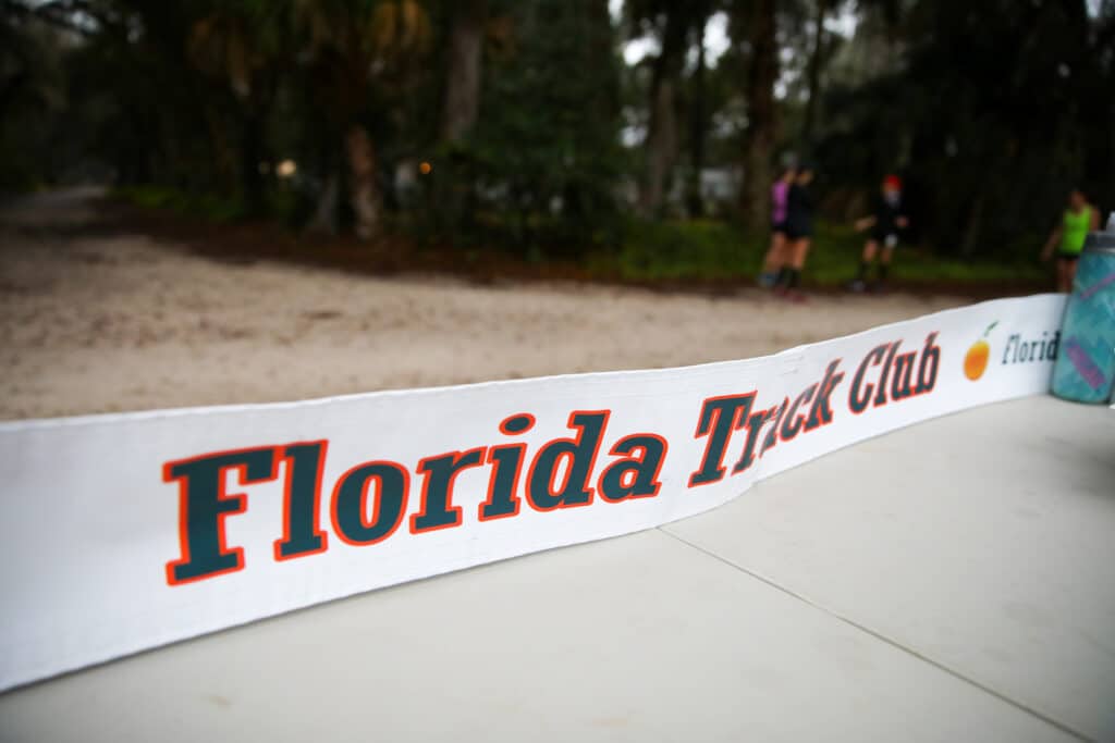 A finish line banner for the Florida Track Club stretched across a running path in Gainesville.